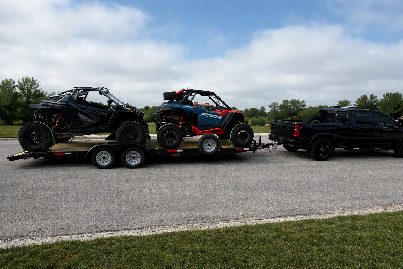 Two Polaris RZRs loaded on a trailer ready for a ride