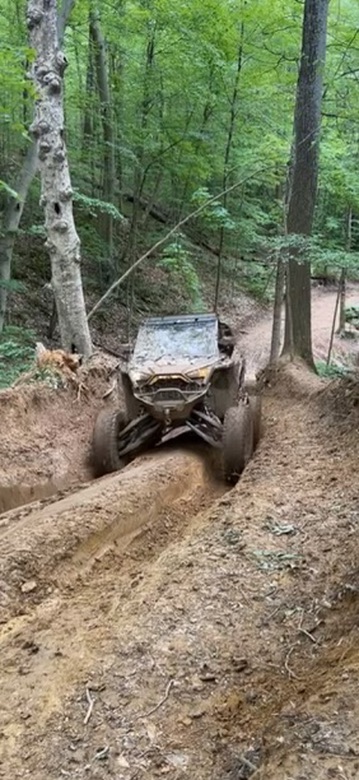 RZR climbing a steep muddy trail